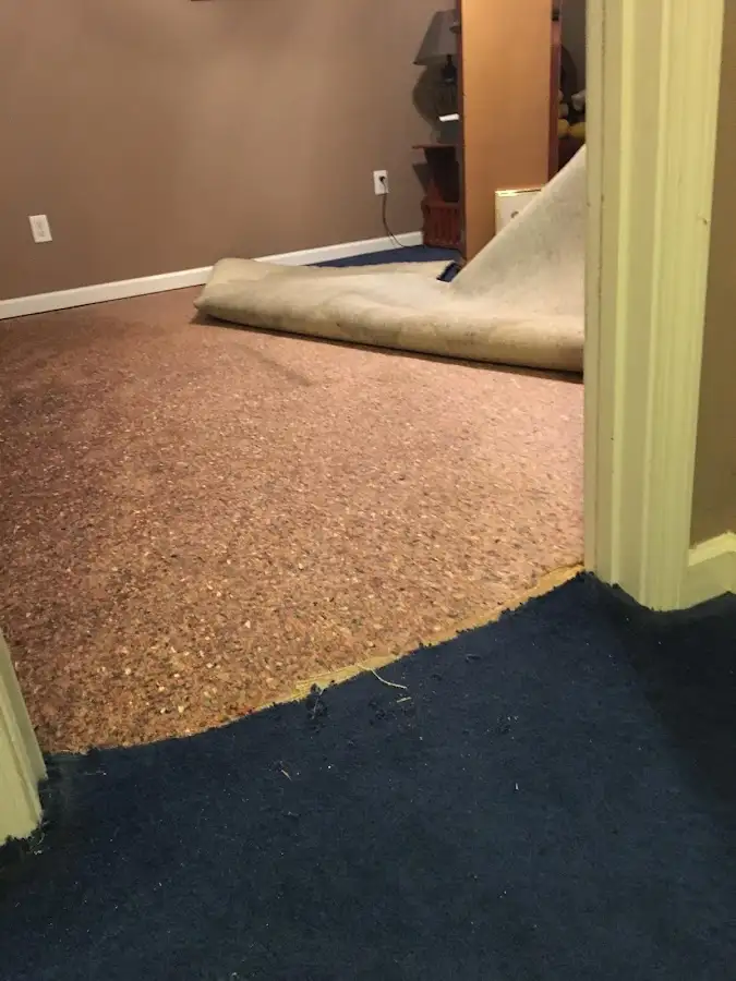 Carpet pad removal revealing water damage during Drying & Dehumidification in Sioux Falls